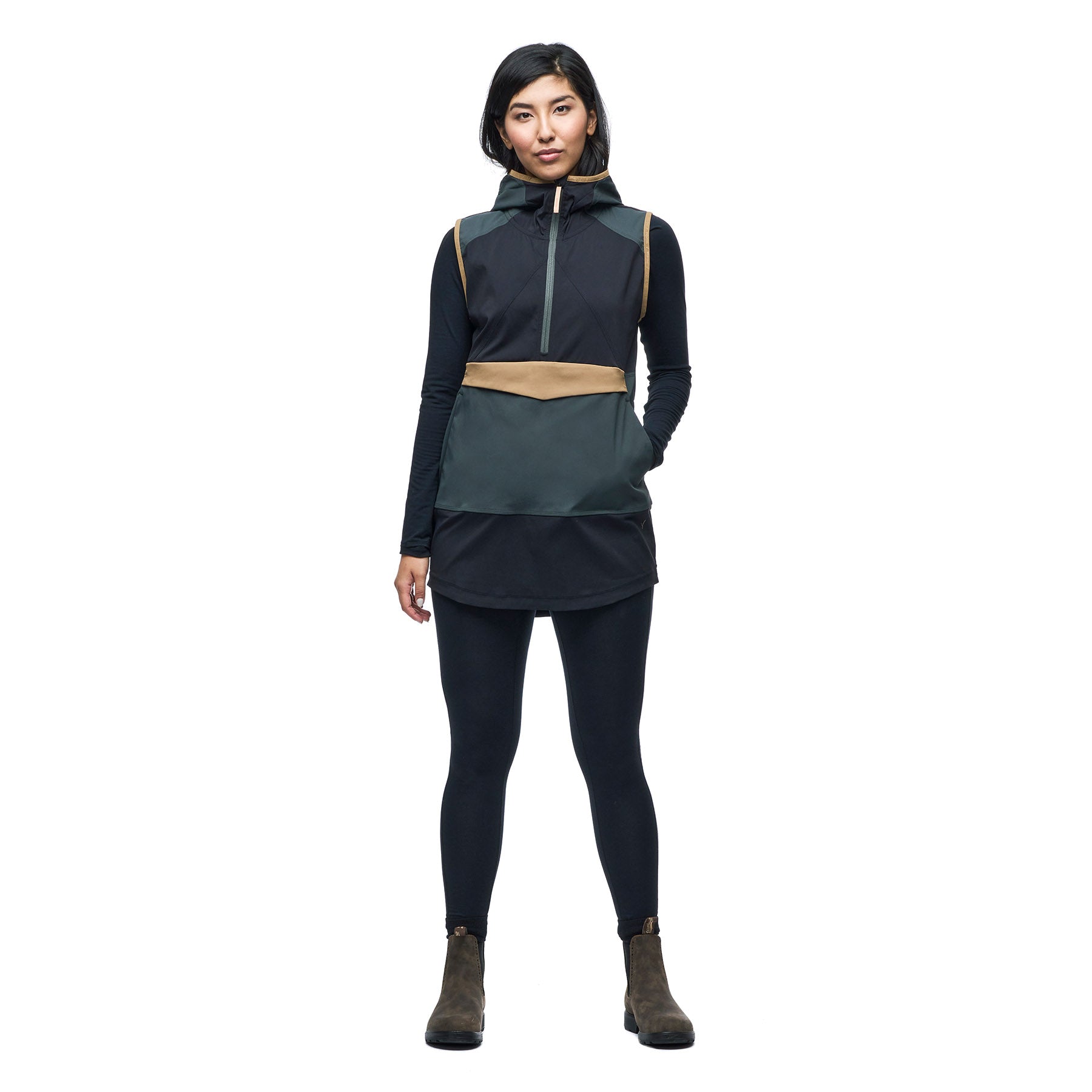 Hero image of a female model wearing the Indyeva Cangur pullover vest in pine black.
