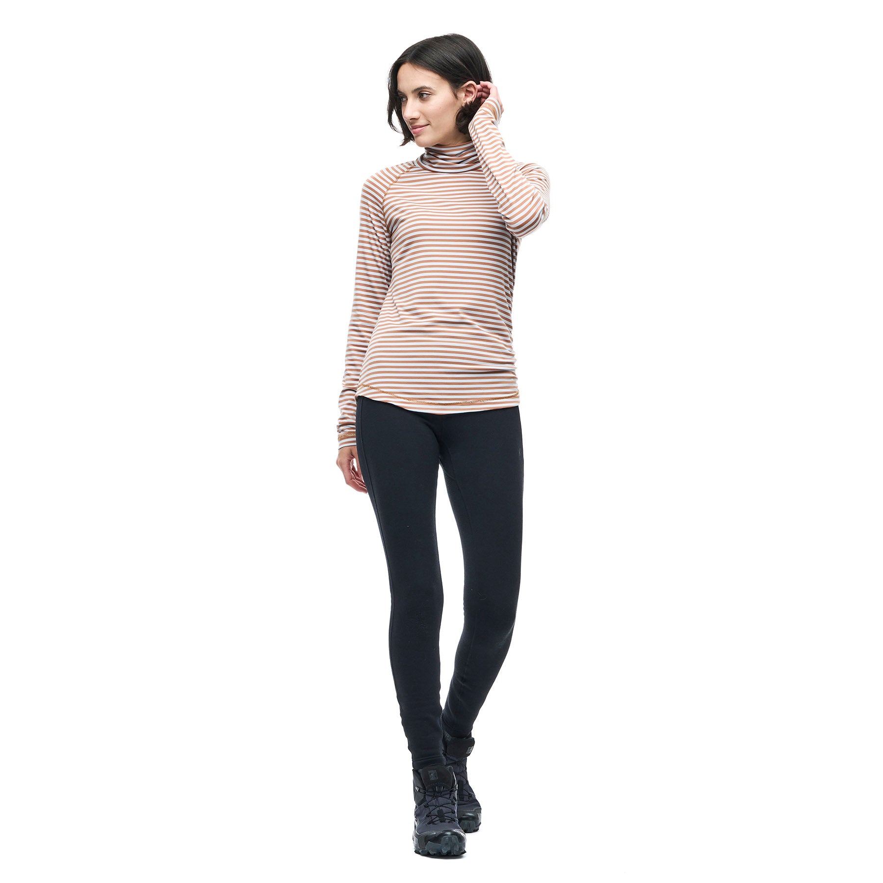 Hero image featuring a front facing model wearing the Indyeva Riga II long sleeve in white with red stripes and black leggings.