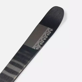 Image features the tip of the Men's K2 Mindbender 85 ski in black with grey stripes and grey K2 logos moving down the ski.