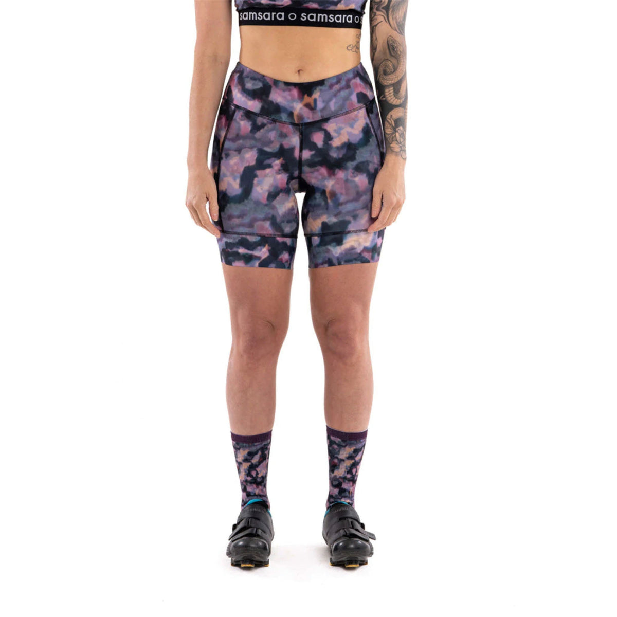Hero image featuring the front of the Samsara performance 7" cycling shorts in a dark watercolor camo 