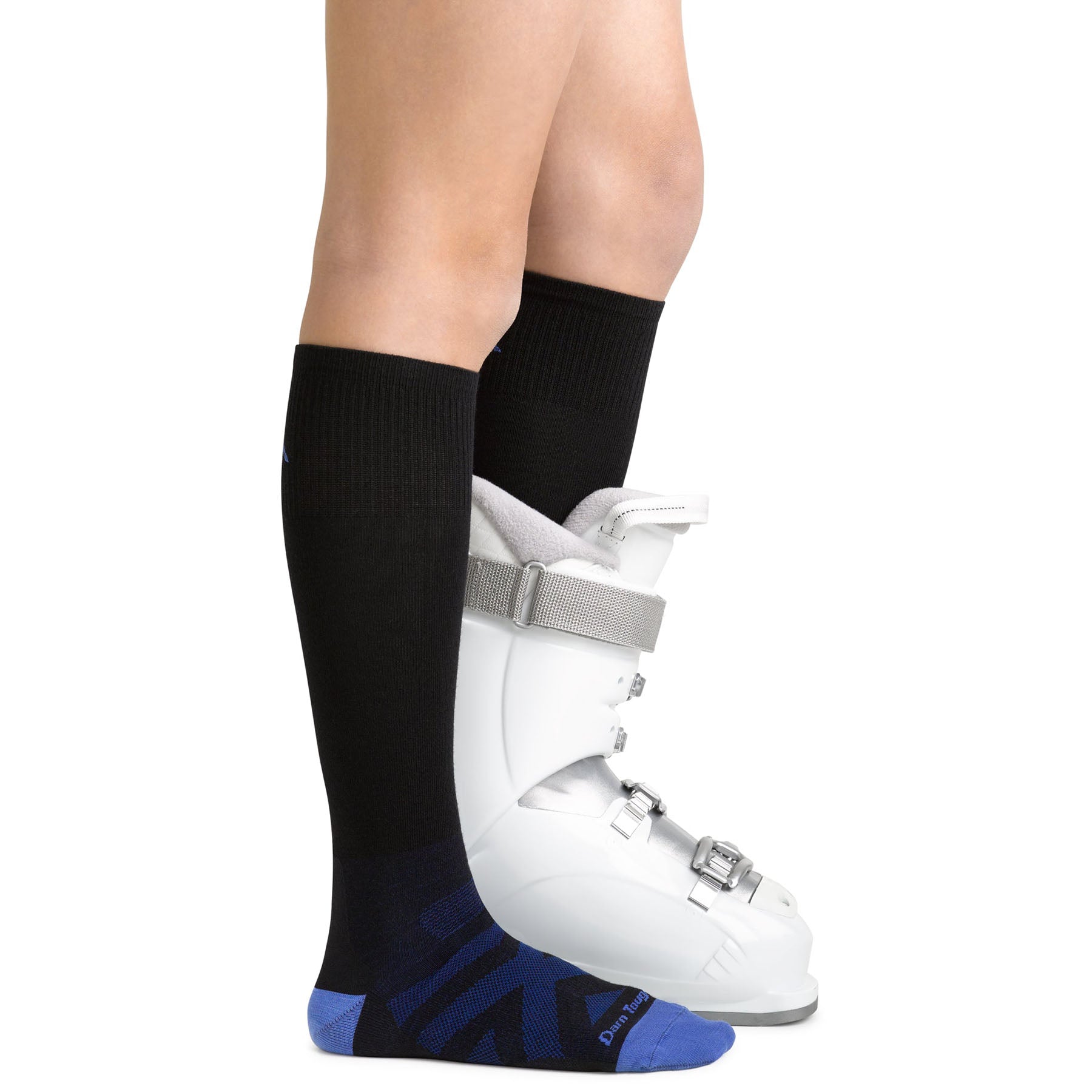 Knee down image of a child model with the RFL sock on their right foot and the sock and a ski boot on the left.
