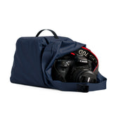 Hero image of ombre blue cabrillo dry bag with camera sitting in the opening of the bag