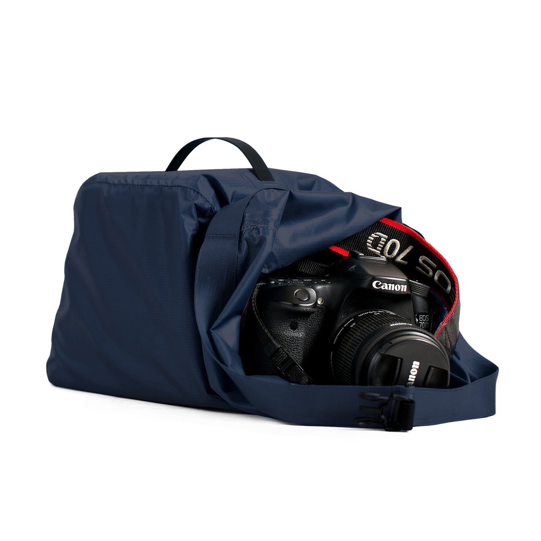 Hero image of ombre blue cabrillo dry bag with camera sitting in the opening of the bag