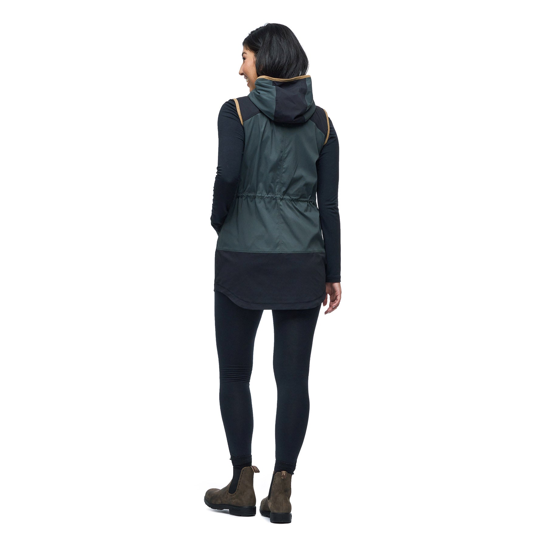 Hero image featuring the back of a female model wearing the Indyeva Cangur pullover vest in pine black.