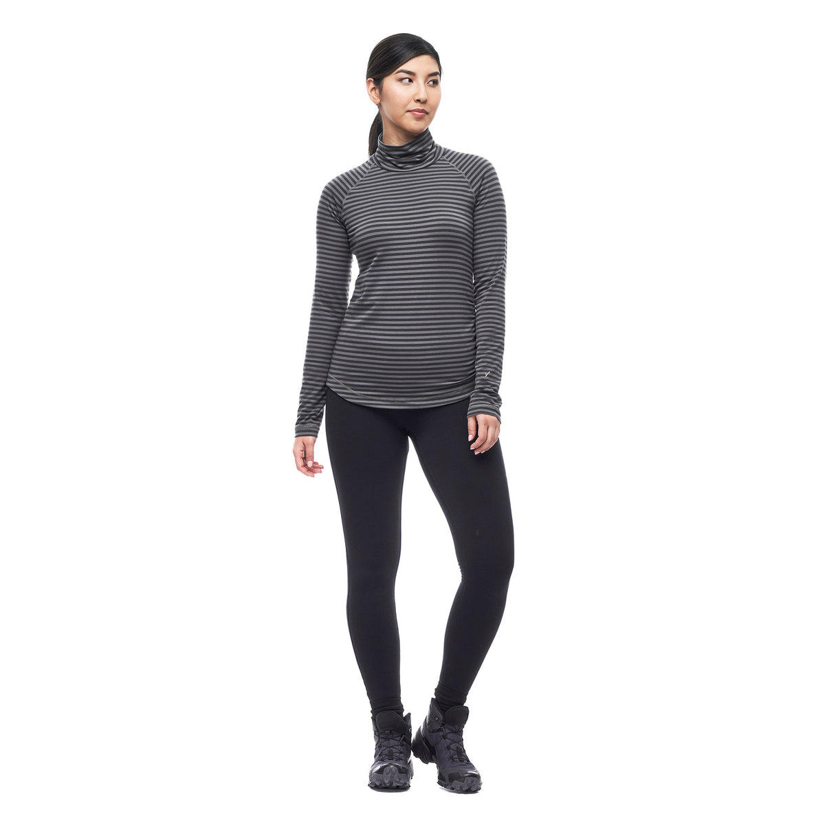 Hero image featuring a front facing model wearing the Indyeva Riga II long sleeve shirt in pine ivy with black leggings.