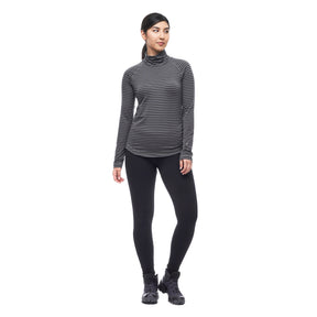 Hero image featuring a front facing model wearing the Indyeva Riga II long sleeve shirt in pine ivy with black leggings.