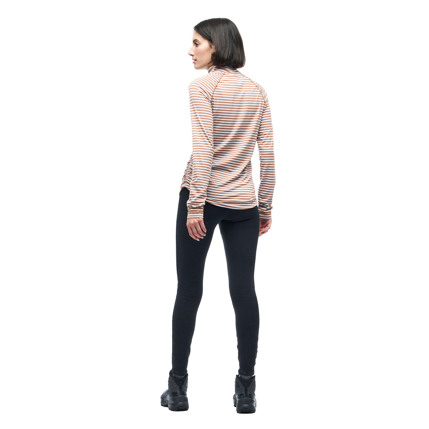 Image features a back facing model wearing the Indyeva Riga II long sleeve in white with red stripes and black leggings.