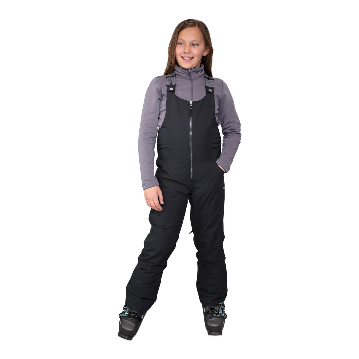Hero image featuring a model wearing the Obermeyer girls Any Bib Pant in black with black ski boots and a grey long sleeve.
