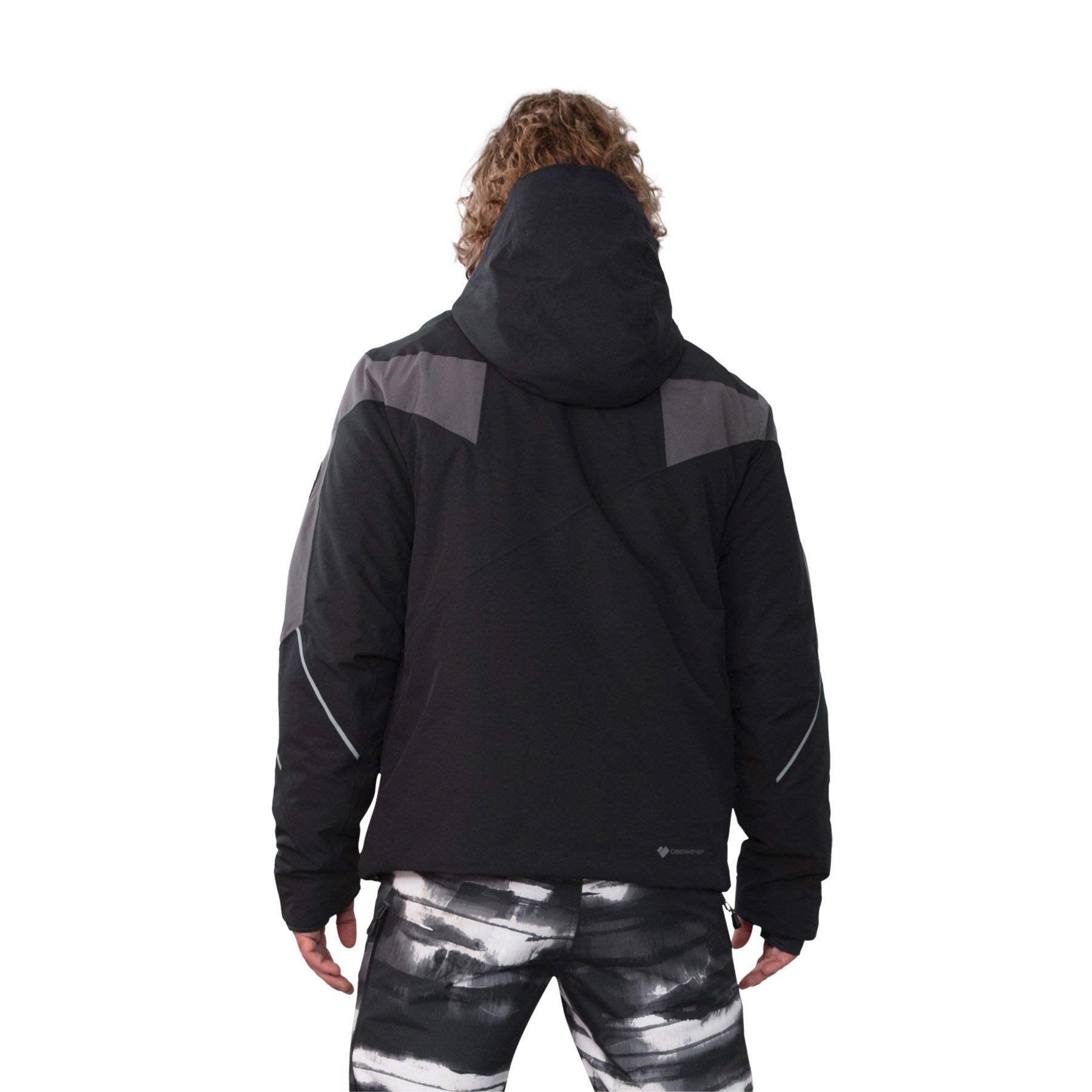 Image features the back of a male model wearing the Obermeyer Charger Jacket in black with grey accents across the back of the shoulders.