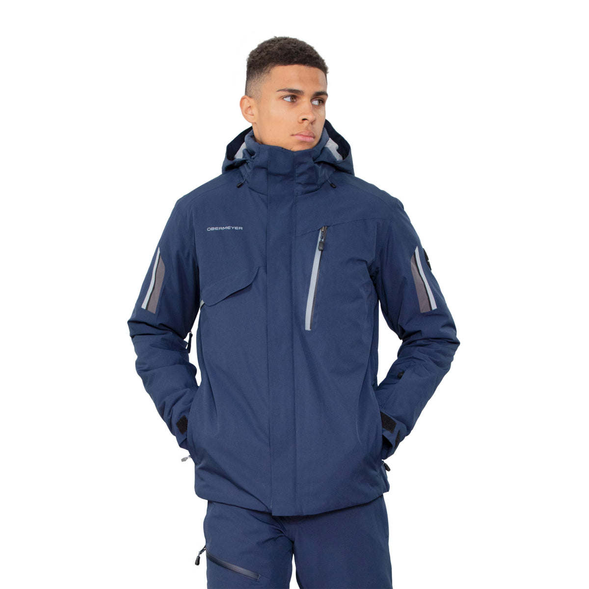 Hero images featuring a male model wearing the Obermeyer Primo Jacket in admiral blue with light grey trim on the sleeves and chest.