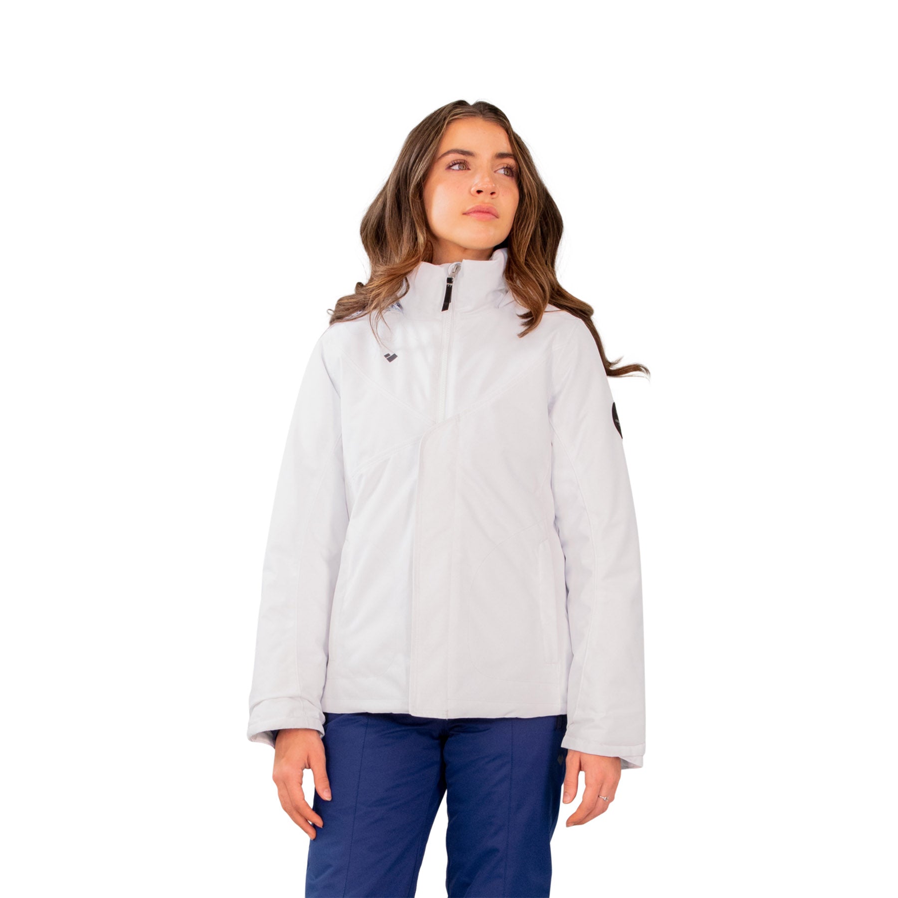 Image features a female model wearing the Obermeyer girls Rylee Jacket in white with blue ski pants.