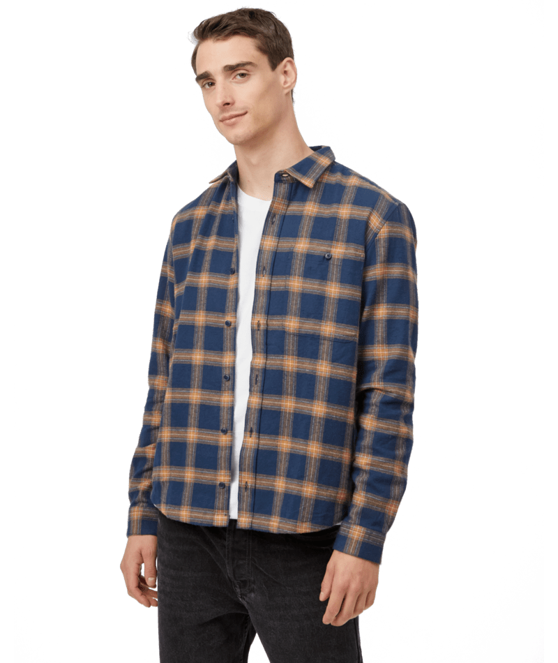 Hero image featuring a male model wearing black jeans and the Ten Tree Kapok Shirt in blue with brown stripes.