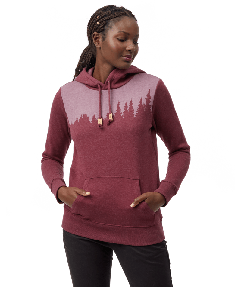Hero image featuring a female model wearing black jeans and the Ten Tree Juniper Hoodie in fig red.